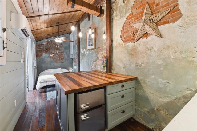 interior space featuring hardwood / wood-style floors, lofted ceiling, ceiling fan, wooden ceiling, and a wall mounted air conditioner