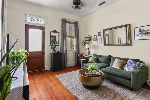 interior space with wood-type flooring, ceiling fan, and a healthy amount of sunlight