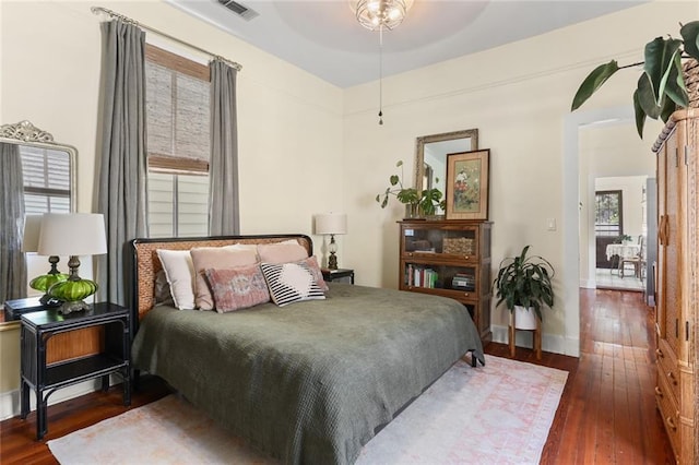 bedroom with dark hardwood / wood-style flooring and ceiling fan