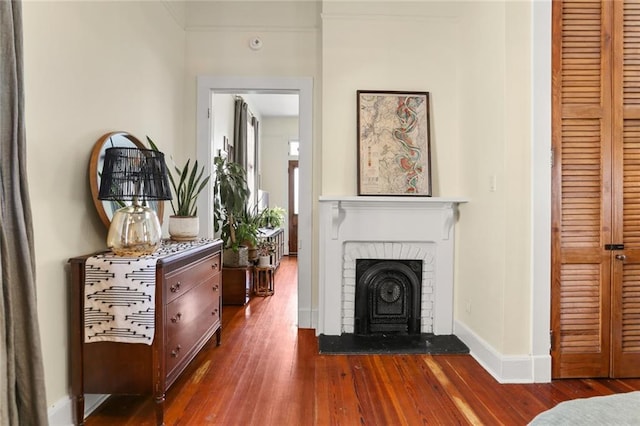 sitting room featuring crown molding and dark wood-type flooring