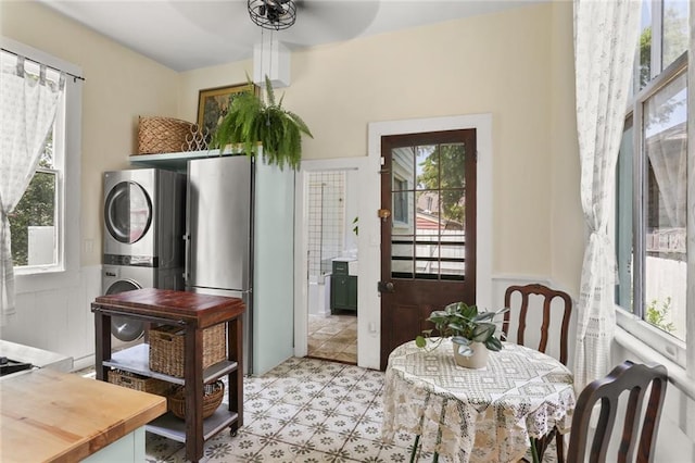 dining room featuring stacked washer and clothes dryer and ceiling fan