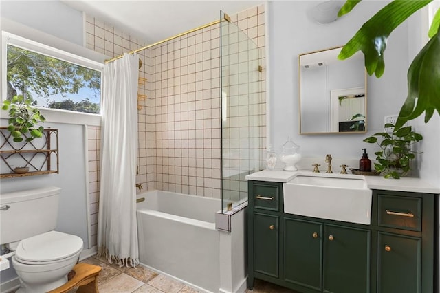 full bathroom featuring tile patterned floors, shower / tub combo, toilet, and vanity