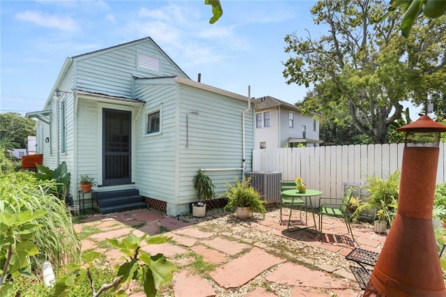 rear view of house featuring a patio area and central AC unit