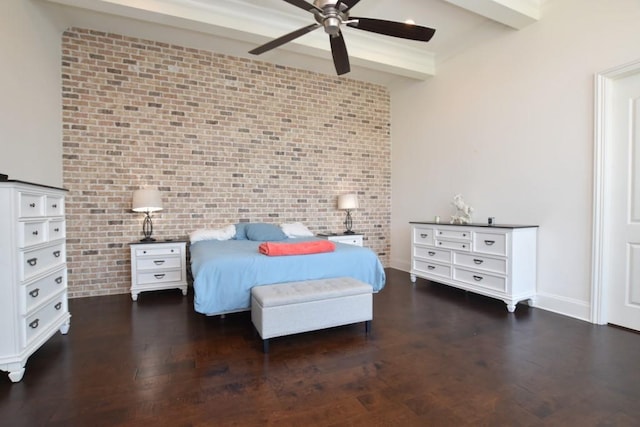 bedroom featuring dark wood-type flooring, brick wall, ceiling fan, and beam ceiling