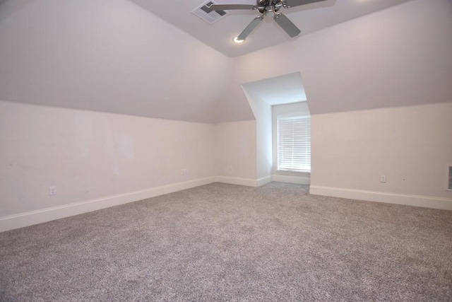 additional living space featuring carpet, ceiling fan, and vaulted ceiling