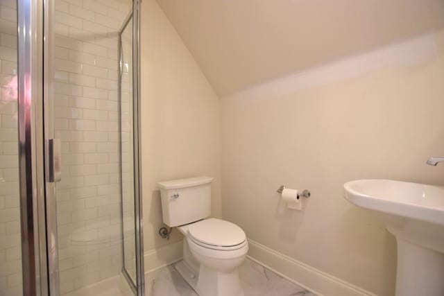 bathroom featuring toilet, vaulted ceiling, and a shower with door