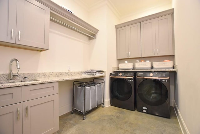 washroom featuring separate washer and dryer, cabinets, and sink