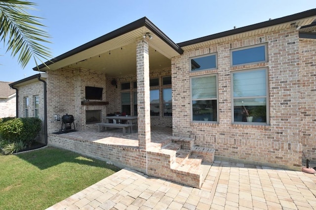 view of patio with a fireplace