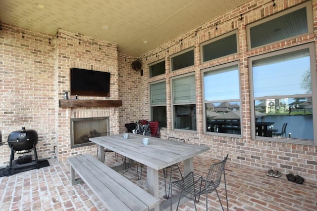 view of patio / terrace featuring an outdoor fireplace and area for grilling