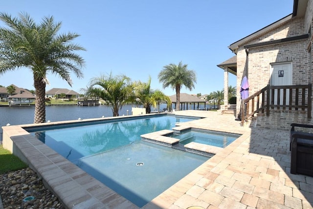 view of pool with a water view, an in ground hot tub, and a patio area