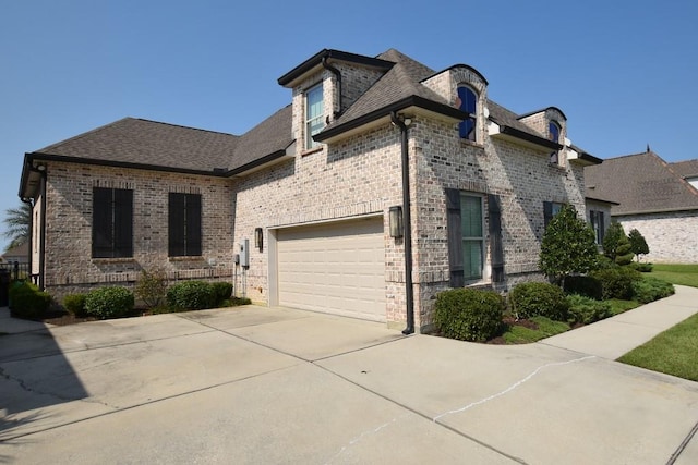 french provincial home with a garage