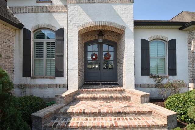 view of exterior entry featuring french doors