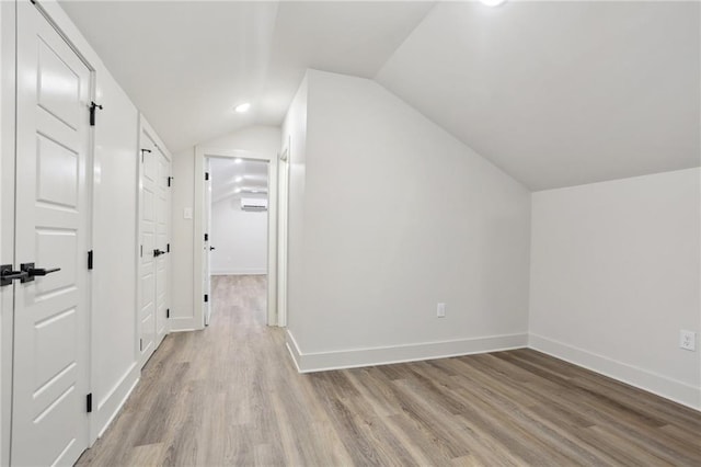 bonus room featuring vaulted ceiling and light hardwood / wood-style flooring