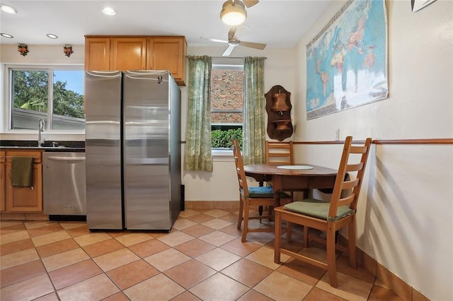 kitchen with light tile patterned flooring, ceiling fan, sink, and stainless steel appliances