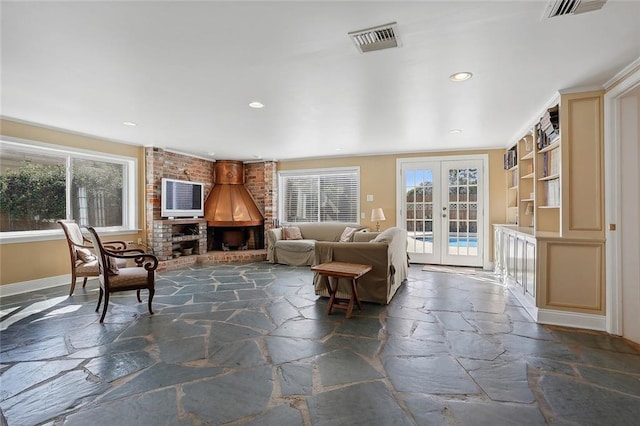 living room with french doors and a brick fireplace