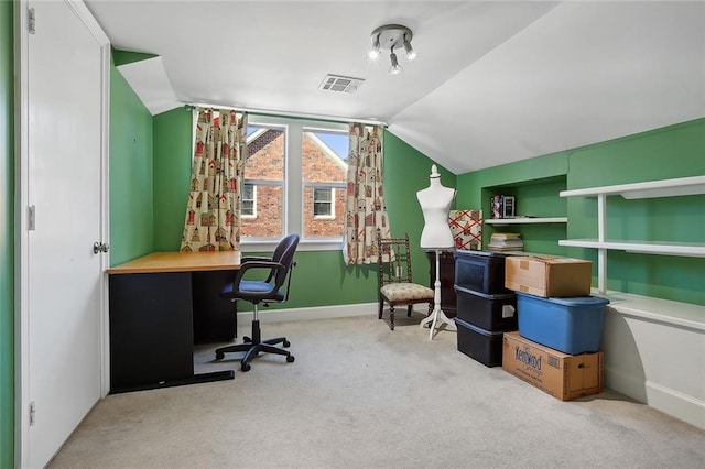 home office featuring light carpet and lofted ceiling