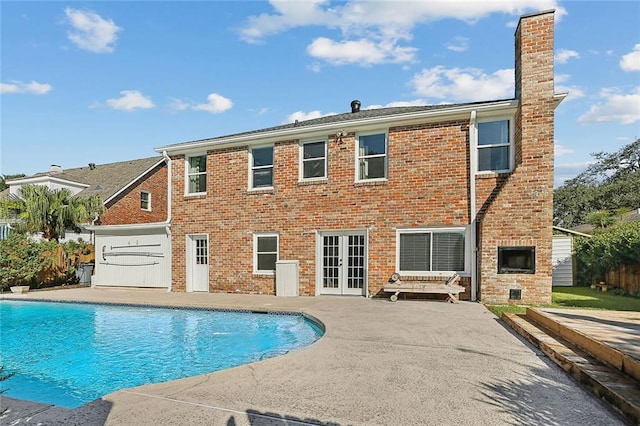 back of property featuring french doors and a patio area