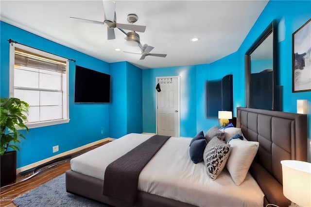 bedroom with wood-type flooring and ceiling fan