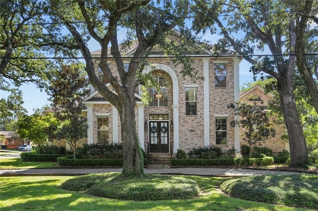 view of front of property with french doors and a front yard