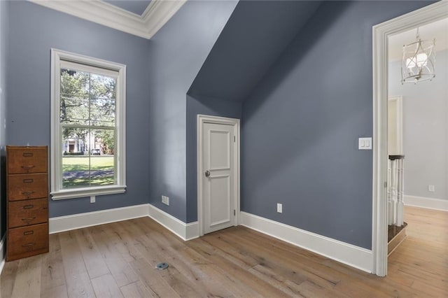 additional living space featuring light hardwood / wood-style floors and an inviting chandelier