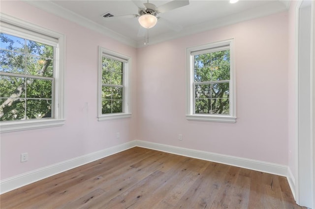 empty room with ceiling fan, light wood-type flooring, and crown molding