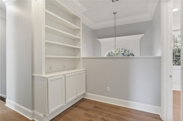 interior space featuring hardwood / wood-style flooring and crown molding