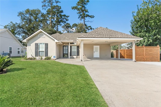 view of front of property with a front lawn and a carport