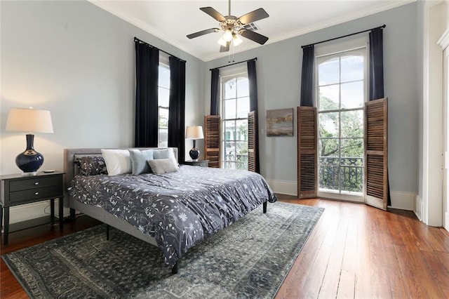 bedroom featuring hardwood / wood-style flooring, ceiling fan, and ornamental molding