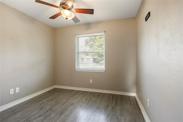 empty room featuring ceiling fan, dark hardwood / wood-style flooring, and a textured ceiling