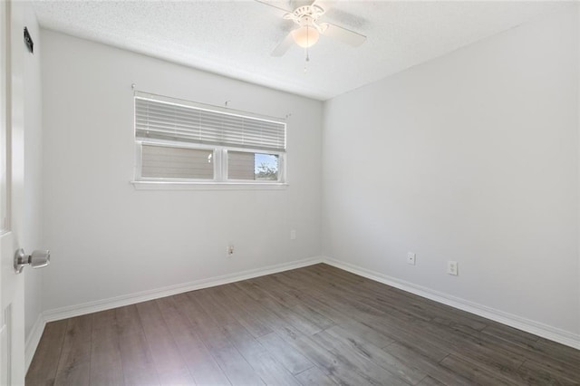 spare room with ceiling fan, dark hardwood / wood-style flooring, and a textured ceiling