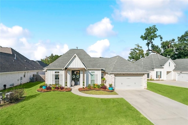 view of front of property featuring central AC unit, a front yard, and a garage