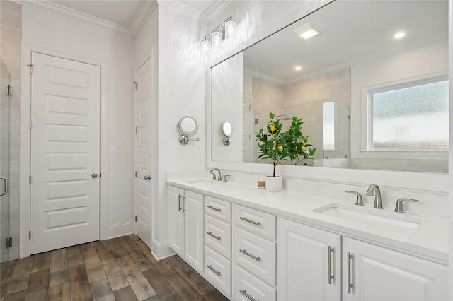 bathroom featuring ornamental molding, an enclosed shower, vanity, and hardwood / wood-style flooring