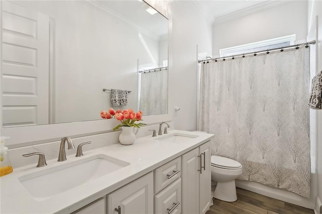 full bathroom featuring shower / bath combination with curtain, crown molding, vanity, hardwood / wood-style floors, and toilet