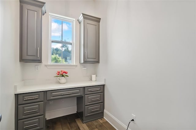 home office with dark wood-type flooring