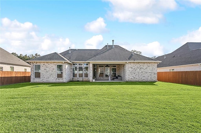 back of property featuring ceiling fan, a yard, and a patio area