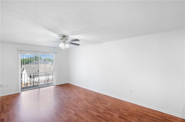 spare room with ceiling fan, wood-type flooring, and a textured ceiling