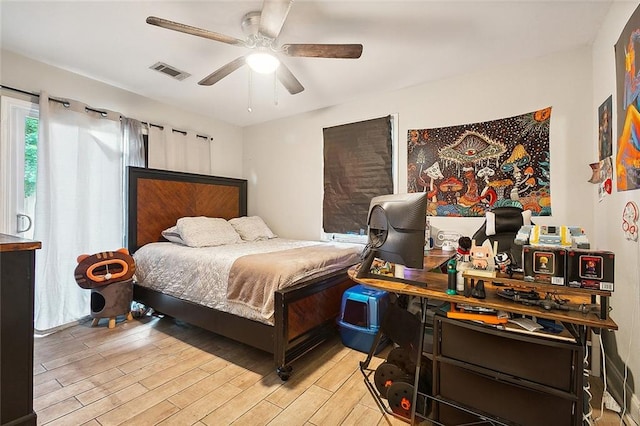 bedroom with light hardwood / wood-style floors and ceiling fan