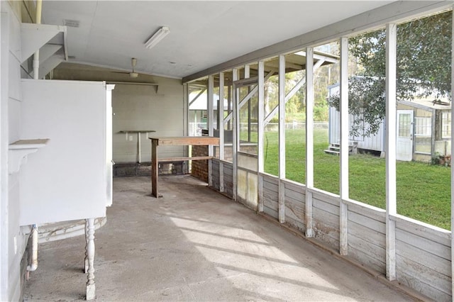 unfurnished sunroom with a healthy amount of sunlight and lofted ceiling