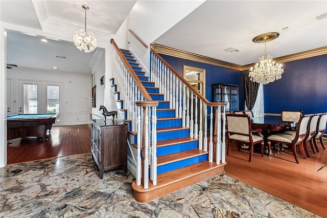 staircase featuring wood-type flooring, crown molding, billiards, a notable chandelier, and french doors