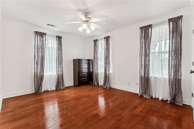 spare room featuring ornamental molding, ceiling fan, and dark hardwood / wood-style flooring