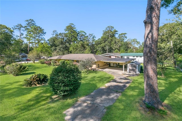 exterior space featuring a front lawn, a shed, and a carport