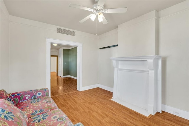 living room featuring ceiling fan and hardwood / wood-style flooring