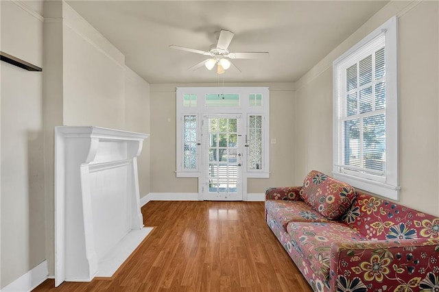 living room with hardwood / wood-style flooring and ceiling fan