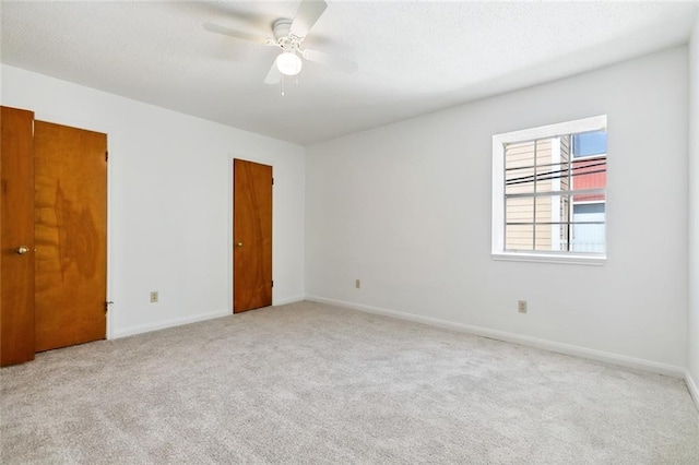 unfurnished room with light carpet and ceiling fan