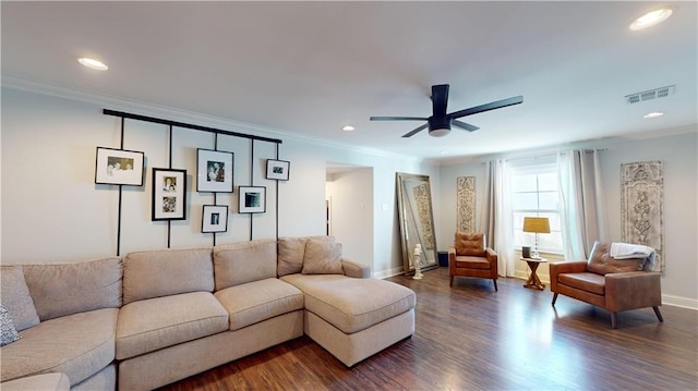 living room with crown molding, ceiling fan, and dark hardwood / wood-style floors