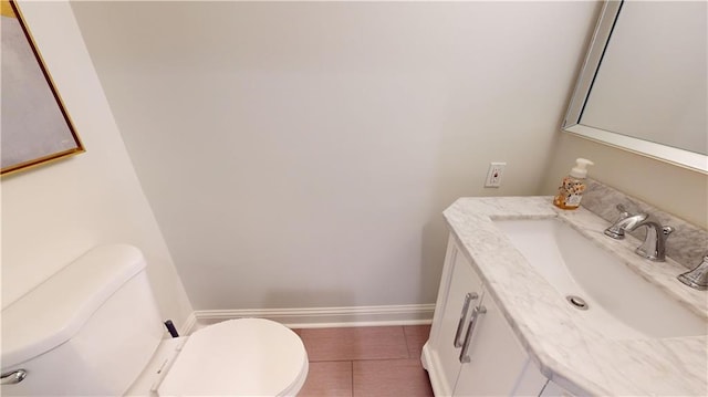 bathroom with vanity, toilet, and tile patterned floors