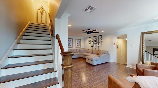 stairway featuring wood-type flooring, crown molding, and ceiling fan