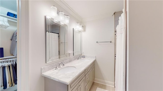 bathroom featuring ornamental molding and vanity