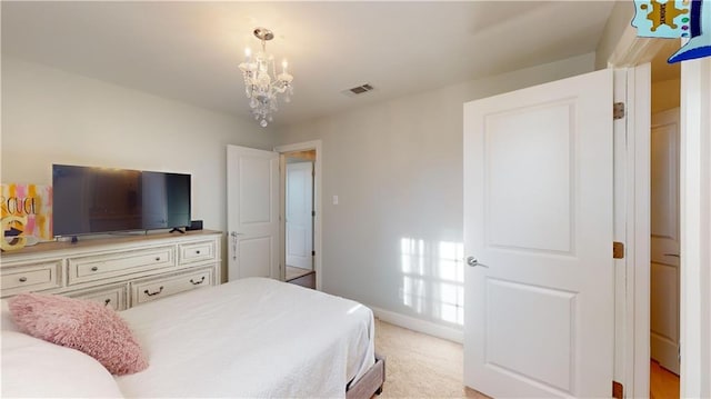 carpeted bedroom with a notable chandelier