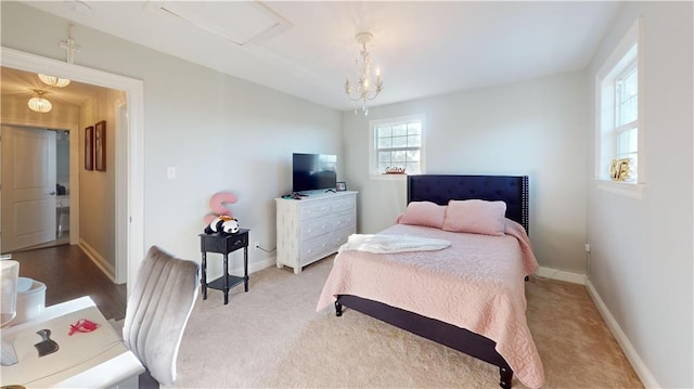 carpeted bedroom featuring a chandelier